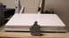 1999 Ford Taurus - A small statue sits before a white Apple laptop, with household items visible in the background.