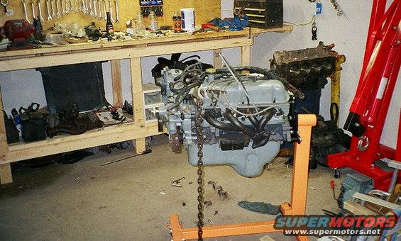 Engine on an orange engine stand in a workshop