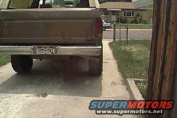 Rear view of a brown pickup truck with a license plate reading '025 EKL'