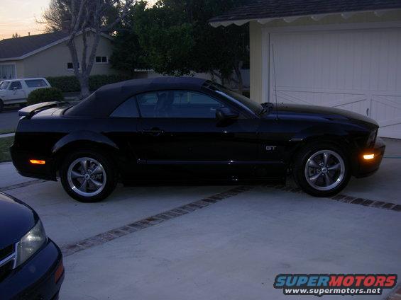 Black 2005 Ford Mustang GT convertible parked in driveway