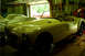 1959 MG A - A yellow convertible sports car is parked inside a garage, with another vehicle visible through the open garage door.