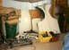 1959 MG A - Various car parts, including fenders and interior pieces, are organized in a storage area.