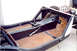 1959 MG A - The chassis of a car, wooden floorboards and an exposed frame, is shown from an interior perspective.