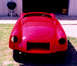 1959 MG A - The rear of a red sports car body is shown, with the interior visible through the windshield.