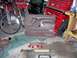 1991 Ford Bronco - A brown Ford Bronco door panel is displayed on a garage floor alongside other vehicle parts and tools.