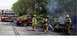 1989 Ford Bronco - Firefighters battle a car fire on the roadside, with a fire engine and a Jeep nearby.