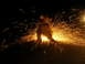 1989 Ford Bronco - A person operates an angle grinder at night, illuminating the darkness with a spectacular display of sparks.
