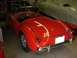 1959 MG A - The rear view of a classic red convertible sports car, showing its chrome bumper and wire wheels.
