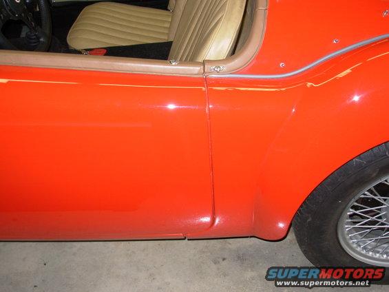 The flash is washing out some of the color.  The car is actually very red.