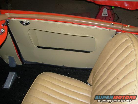 1959 MG A interior showing tan door panel with map pocket and tan seat