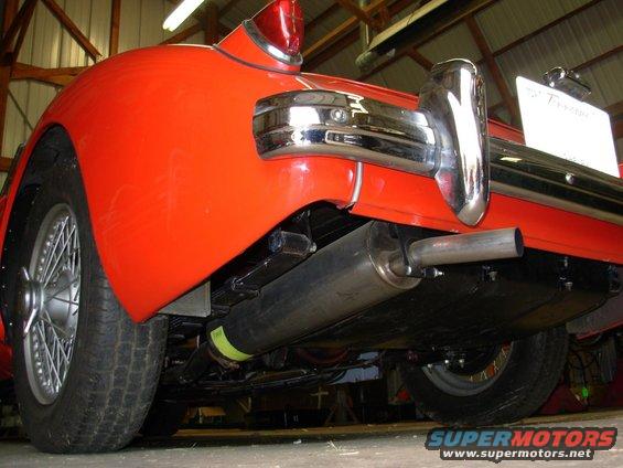 Red 1959 MG A rear bumper and exhaust system, viewed from below