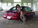 1998 Ford Taurus - A red 1998 Ford Taurus sedan is shown from the rear in an unfinished garage.