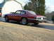 1992 Jaguar XJ-S - Rear view of a red 1992 Jaguar XJ-S coupe with smoking exhaust.