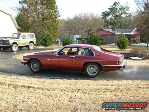 Red 1992 Jaguar XJ-S coupe, side view, wire wheels, exhaust smoke