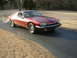 1992 Jaguar XJ-S - A red 1992 Jaguar XJ-S coupe is shown from the front-right on a paved driveway.