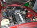 1992 Jaguar XJ-S - The engine bay of a red car reveals a "CORVETTE" engine, contradicting the registry's claim.