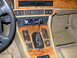 1992 Jaguar XJ-S - The interior of a 1992 Jaguar XJ-S features wood grain trim, an automatic transmission shifter, and a digital clock displaying 12:36.