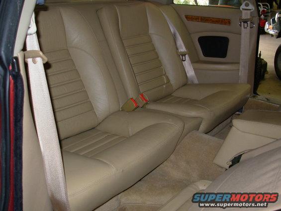 Tan leather rear seats with ribbed pattern and beige seatbelts in a 1992 Jaguar XJ-S