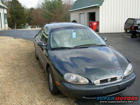 1999 Mercury Sable sedan parked outside a building