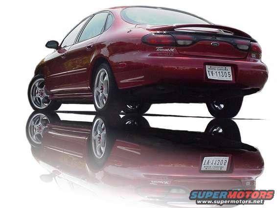 1998 Ford Taurus SE rear quarter view, red paint, custom wheels
