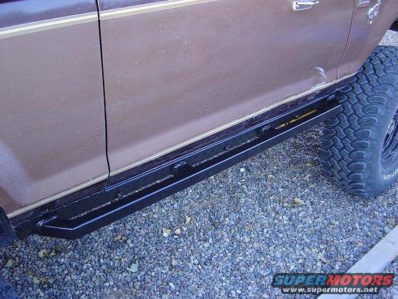 Brown 1986 Ford Bronco II side view with running boards and off-road tire
