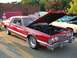 1976 Ford Thunderbird - Red 1976 Ford Thunderbird coupe with hood open, parked outdoors with other vehicles.