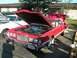 1976 Ford Thunderbird - A red 1976 Ford Thunderbird is displayed with its hood open, revealing the engine bay.