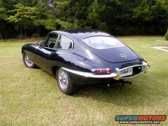 Dark blue 1967 Jaguar XKE coupe, rear 3/4 view, wire wheels, chrome bumper, license plate DBA 316