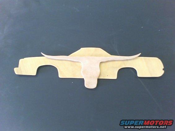 Wooden cutout of a pickup truck profile with a longhorn skull graphic superimposed