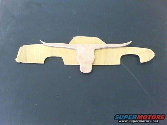 Wooden cutout of a pickup truck with a longhorn skull overlay