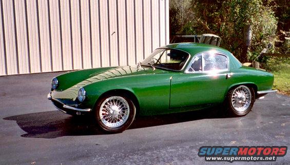 Green 1960 Lotus Elite coupe with wire wheels parked on asphalt