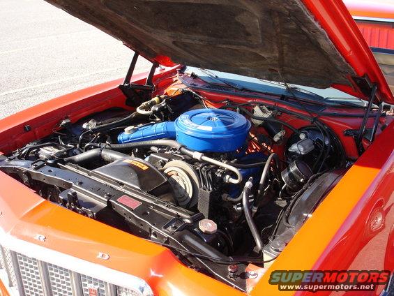 Orange 1979 Ford Ranchero engine bay with blue air cleaner and visible engine components