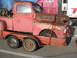 1952 Ford Pickup - A weathered red pickup truck, likely from the late 1940s, is secured to a trailer.