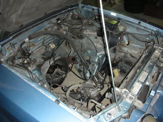 Blue 1990 Ford Mustang engine bay with engine removed