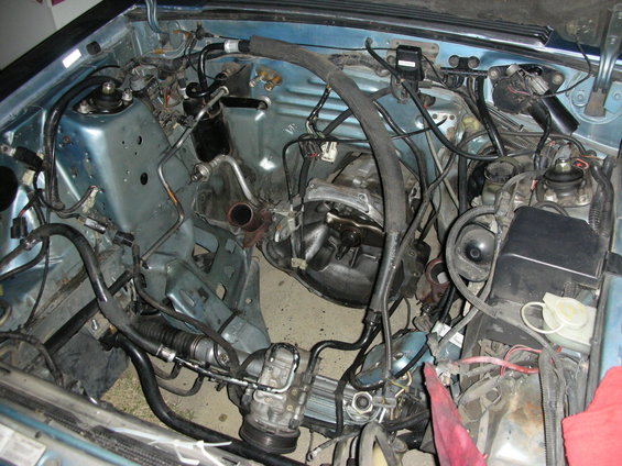 Engine bay with transmission and steering components visible