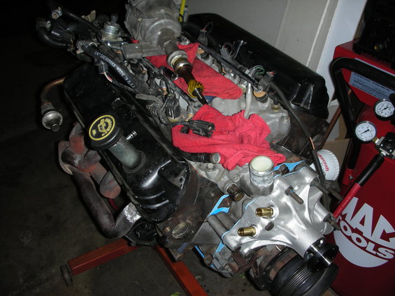 Engine on stand with red rags, MAC Tools equipment nearby