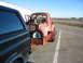 1952 Ford Pickup - A red 1952 Ford Pickup truck is seen from the rear, loaded onto a trailer and being towed.