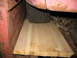 1952 Ford Pickup - A close-up view of a vehicle's fender and tire, supported by a wooden plank.