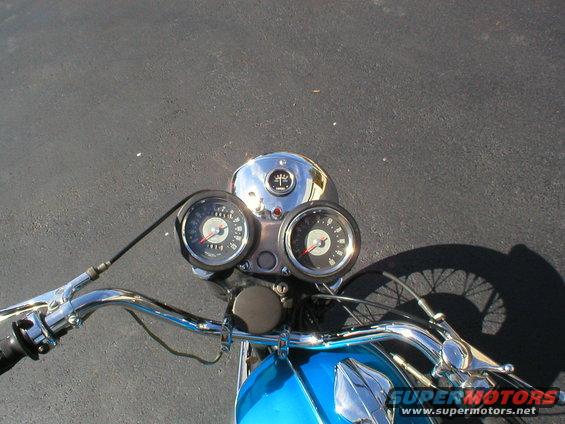 Chrome handlebars and dual gauges on a blue 1968 BSA Lightning motorcycle