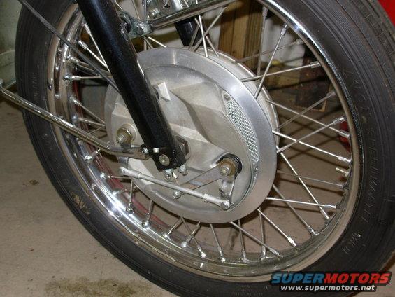 Motorcycle front wheel and brake assembly with chrome spokes and silver brake drum