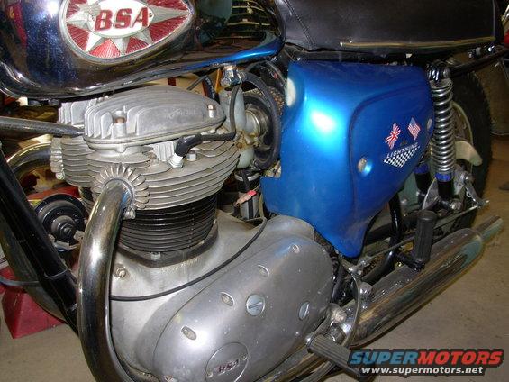 BSA motorcycle engine with chrome exhaust and blue side panel with Union Jack and checkered flag decals