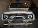 1990 Ford Bronco - Front view of a white Suzuki Samurai, showing the grille and headlights.