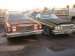 1979 Ford Ranchero - Two older vehicles, a red one and a green one, are parked side-by-side in an outdoor lot.