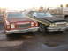 1979 Ford Ranchero - Two Ford Rancheros are parked together. The red one has a camper shell, the green one has a stripe.