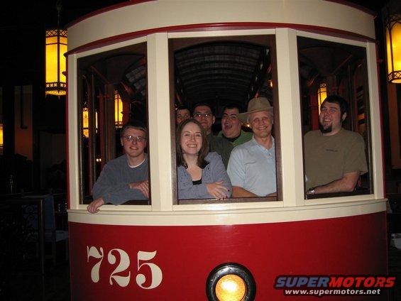 Red and cream streetcar with number 725, interior view of people looking out windows