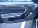 1984 BMW 3 Series - Close-up of a car's interior door panel, showing the armrest and window controls.