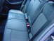 1984 BMW 3 Series - Interior view of the rear seats and seatbelts, showing the blue upholstery and door panel.