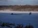 1971 Porsche 914 - A car is stuck in the ice on a frozen lake, with two onlookers observing the scene.