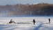 1971 Porsche 914 - A vehicle is stuck in the ice on a frozen body of water, with two individuals observing the scene.