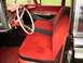 1959 Ford Fairlane - Interior view of a 1959 Ford Fairlane, highlighting the red and black striped seats and steering wheel.